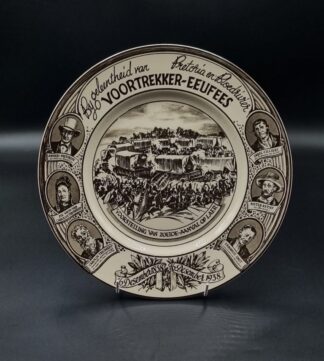 LOT 145 (32820) Est R300 to R600 - A Royal Doulton Commemorative Voortrekker Eeufees Glazed Earthenware Rack Plate, dated 1938 (Grey colourway)