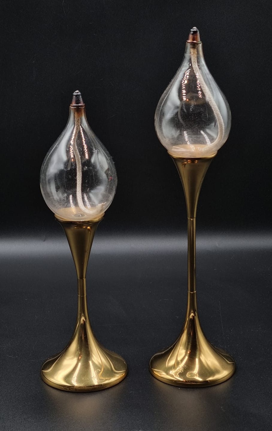 LOT 332 () Est R1000 to R3000 – A Rare graduated pair of West German Space Age footed Clear Drops Brass Mount Oil Lamps (Ollampen) circa 1970s
