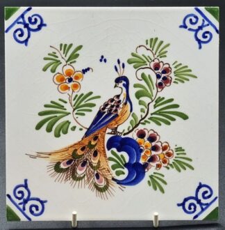 LOT 119 (33032) Est R300 to R600 - A Polychrome Delfts Glazed Earthenware Peacock Amongst Asters and foliage Tile