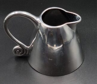 LOT 34 (32798) Est R400 to R800 - A Carrol Boyes Cast Aluminium Cone Milk Jug, Wave