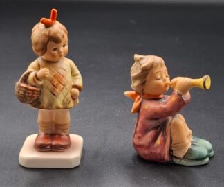 LOT 123 (3293530/43) Est R200 to R400 - A Late 20th Century German  M.I. Hummel Club porcelain figurine, I Brought You a Gift (Ich bring dir was)