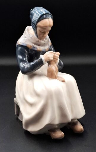 LOT 145 (33119) Est R1000 to R3000 - A Royal Copenhagen Figurine, Amager Woman Knitting" (or Strikkende Amagerpige)