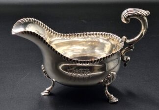 LOT 35 (329542) Est R6000 to R12000 - An Important Late Victorian Silver George II-style footed Silver Sauceboat
