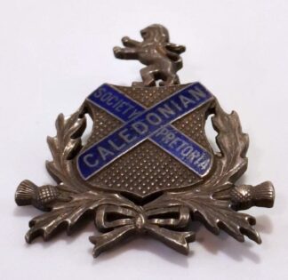 LOT 262 (33174) Est R200 to R400 - A Rare SA Silver and Enamelled Caledonian Society Pretoria Badge