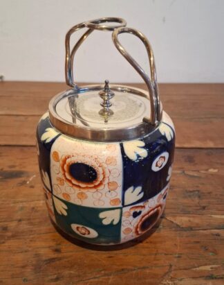 LOT 168 (32974) Est R300 to R600 - An English Transitional period (1915-1925) Glazed Earthenware Biscuit Barrel, fitted with EPNS mounts and finialled cover in the Imari-style
